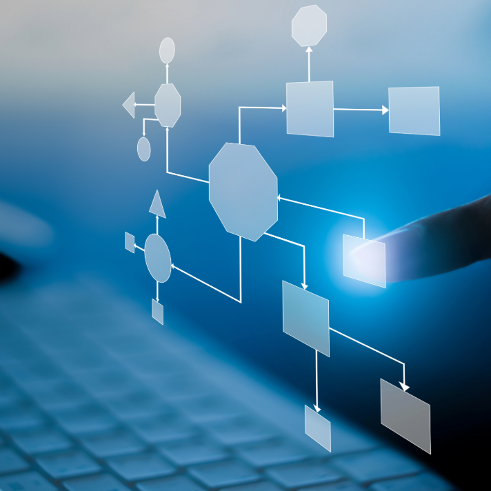 A close-up of a finger touching a glowing interface on a translucent blue screen showing a flowchart or network diagram over a blurred keyboard background.