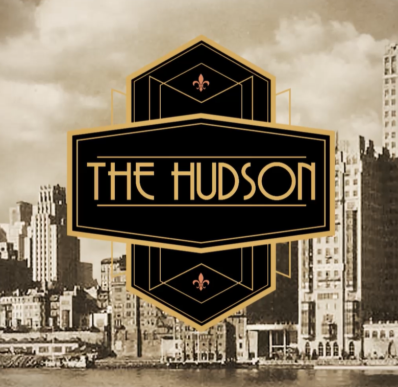 A sepia-toned city skyline with a large black and gold geometric logo in the center reading “THE HUDSON,” with fleur-de-lis details inside the emblem.